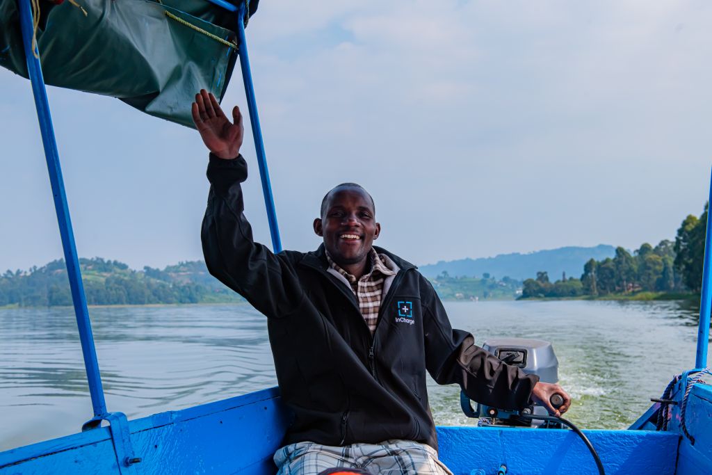 The local boat captain Apollo cruising to the mabamba swamps on an earl morning birding session on lake Bunyonyi