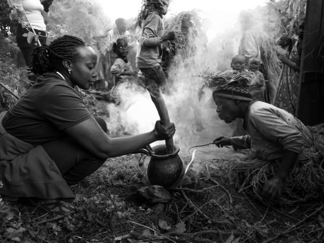 Hillary guiding visitors on the Batwa forest trail near Kisoro