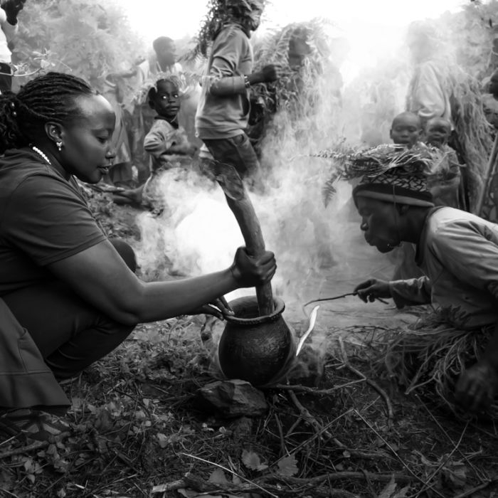 Hillary guiding visitors on the Batwa forest trail near Kisoro